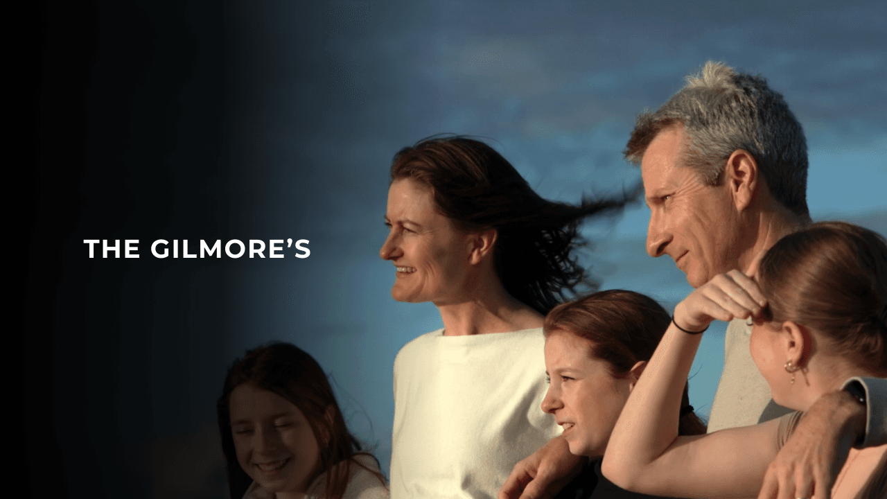 Tesla Live on Sunshine winners the Gilmore's pictured as a family looking towards the ocean with the sun in their face.