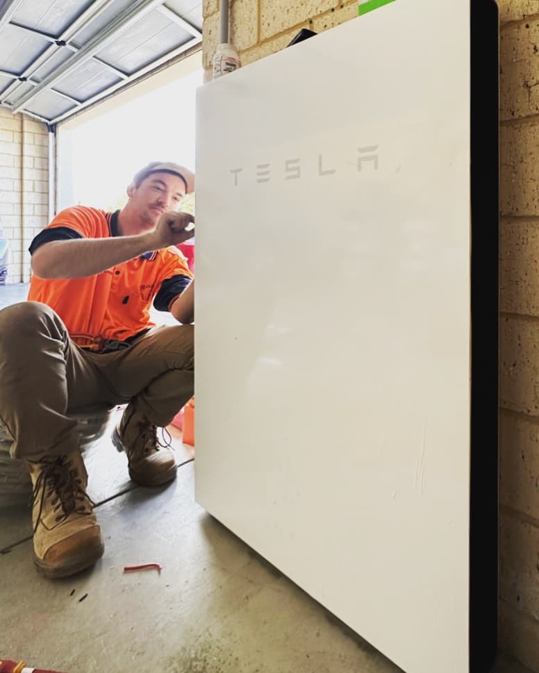 Technician installing a Tesla Powerwall